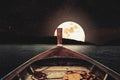 Traveling on wooden boat at night with full moon and stars on sky. scenic panorama with full moon on sea at night, vintage tone Royalty Free Stock Photo