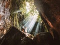 Traveling young couple with tropical rainforest rock in Bali enjoying life at beautiful Lighting hidden waterfall Royalty Free Stock Photo