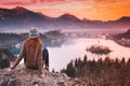 Traveling young woman looking on sunset on Bled Lake, Slovenia,