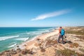 Traveller enjoys the view of the sandy beach of Praia do Malhao Sul on the Atlantic coast near Vila Nova de Milfontes, Odemira,