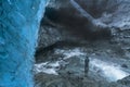 A traveller in front of an icecave in Vatnajokul national park Royalty Free Stock Photo