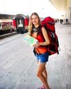Traveller girl female backpack and tourism outfit at railway station