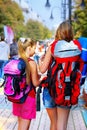 Traveller girls with backpack search way by tourist paper map