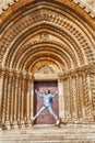 Happy woman in front of The entrance to the Chapel of Jak in Vajdahunyad Castle in Budapest, Hungary