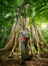 Traveller looking through binoculars considers wild birds in the Royalty Free Stock Photo