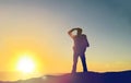 Traveller looking far away over sunrise Royalty Free Stock Photo