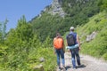 Traveller looking the nature from the high mountain with spotting scope, binoculars tripod