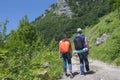 Traveller looking the nature from the high mountain with spotting scope, binoculars tripod