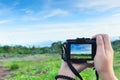 Traveller make photo  using mirrorless camera in hand, travel blogger, Close up of women`s hands holding mirrorless camera taking Royalty Free Stock Photo