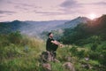 Traveller man with backpack sitting on rock at outdoor,Meditations to calm your mind and body