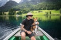 Traveller man with best friend dog on boat Royalty Free Stock Photo