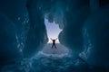 A traveller standing in front of ice cave in Baikal frozen lake in winter season, Siberia in Russia Royalty Free Stock Photo