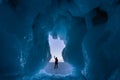 A traveller standing in front of ice cave in Baikal frozen lake in winter season, Siberia in Russia Royalty Free Stock Photo