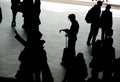 Travellers silhouetted on station concourse