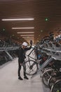 Traveller is surprised by the huge underground cycle station under the main overpass in Amsterdam, Netherlands. Inserting the Royalty Free Stock Photo