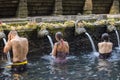 Traveller take a bath at Holy Spring Water Tirta Empul Hindu Temple , Bali Indonesia. Royalty Free Stock Photo