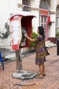 Traveller thai woman using public telephone or payphone booth ca Royalty Free Stock Photo