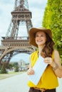 Traveller woman against Eiffel tower with map having excursion Royalty Free Stock Photo