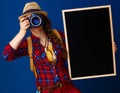 Traveller woman with blackboard taking photo with digital camera Royalty Free Stock Photo