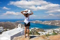 Traveller woman enjoys the view to the beautiful island of Ios, Cyclades, Greece Royalty Free Stock Photo