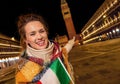 Traveller woman with Italian flag pointing at St Mark`s Campanil Royalty Free Stock Photo