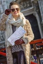 Traveller woman in Milan, Italy with map looking into distance Royalty Free Stock Photo