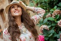 Traveller woman near flowers looking into the distance Royalty Free Stock Photo