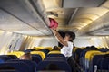 Traveller woman open overhead locker on airplane