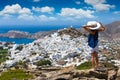 Traveller woman overlooks the town of the island Ios on the Cyclades in Greece Royalty Free Stock Photo