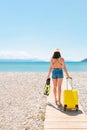 Traveller woman with a suitcase on the beach Royalty Free Stock Photo