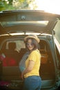 Traveller woman toothy smiling happiness emotion standing back of suv car loading belonging for traveling trip