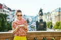 Traveller woman on Vaclavske namesti in Prague writing sms Royalty Free Stock Photo