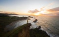 Traveller on steep hill cliff enjoying Pacific Ocean panorama view of Castle Point Lighthouse, Wellington New Zealand Royalty Free Stock Photo