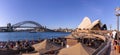 Travellers and local people have drink and enjoy sunny day at Opera bar in front of The Opera House, with a beautiful clear blue