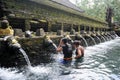 Travellers praying and take a bath at holy spring water
