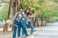 Travellers try to stop car. Friends hitchhikers travelling summer sunny day. Company friends travelers hitchhiking at edge road Royalty Free Stock Photo