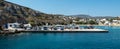 Travellers waiting for the ferry, at the port on Iraklia island Greece.