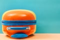 Travelling background. Summer holidays. Time to travel. Summer time. Bright colourful suitcase on blue, copy space Royalty Free Stock Photo