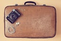 Travelling background. Traveler set. Travel blogging. Top view of suitcase, camera and headphones. Vintage luggage case