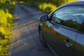 Travelling by car on old asphalt road in country at sunset Royalty Free Stock Photo