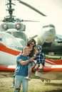 Travelling concept. Family at retro planes parked on ground, travelling. Child with mother and father visit air show