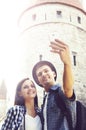 Travelling couple of hipsters: walking around old town. Royalty Free Stock Photo