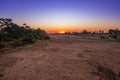 Travelling through a dry river bed landscape covered in acacia trees at sunset, Kruger National Park, Royalty Free Stock Photo