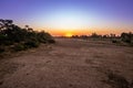 Travelling through a dry river bed landscape covered in acacia trees at sunset, Kruger National Park, Royalty Free Stock Photo