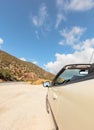 Fashionable luxury empty car with open roof is parking on road. Wonderful landscape with sky in background Royalty Free Stock Photo