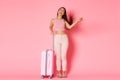 Travelling, holidays and vacation concept. Carefree and sassy asian girl tourist packed bags to go abroad, tossing hair Royalty Free Stock Photo