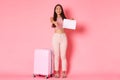 Travelling, holidays and vacation concept. Full-length of friendly smiling asian girl tourist standing near suitcase Royalty Free Stock Photo