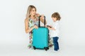 Travelling with kids. Happy mother with her child packing clothes for their holiday. Summer, vacation Royalty Free Stock Photo