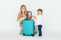 Travelling with kids. Happy mother with her child packing clothes for their holiday. Summer, vacation Royalty Free Stock Photo