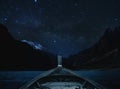 Travelling on lake at night by boat, sky full of star and milky way with mountains valley Royalty Free Stock Photo